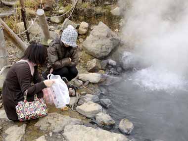 熱湯湯池の側にたたずむ女性、じっと茹で上がるの待っていました。そんな側にいて怖くないのかなと思います。